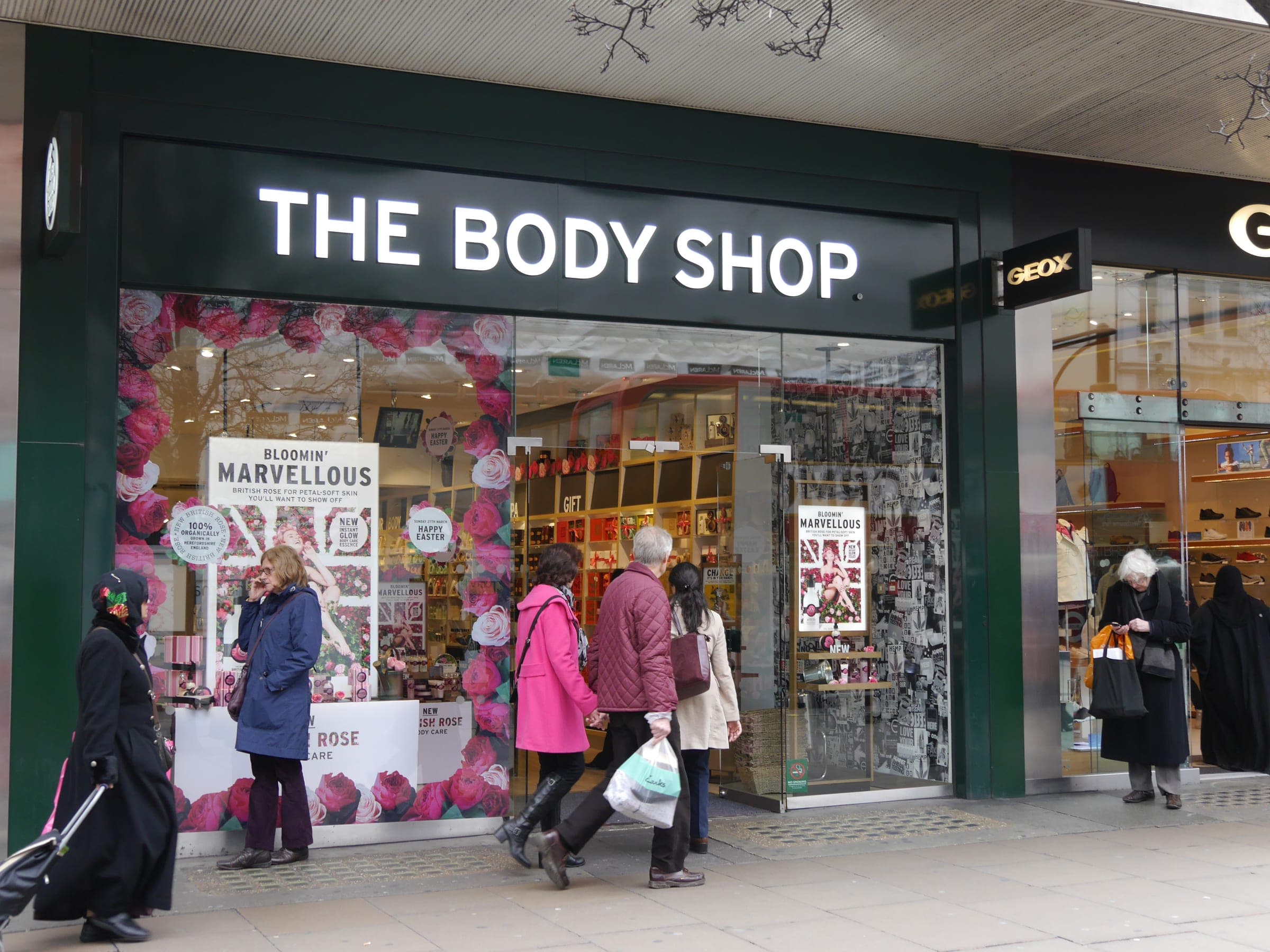 Shoppers passing The Body Shop on Oxford Street, London.